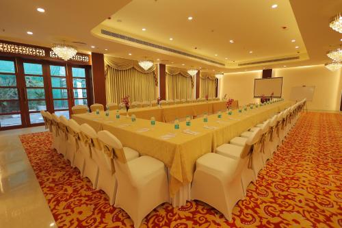 a large banquet hall with a long table and chairs at Regenta Orko's Haridwar, Motichur, 10 min from Har ki Pauri in Haridwār