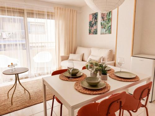 un soggiorno con tavolo e sedie bianchi di Apartamento La Palmera a Torrevieja