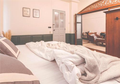 a bedroom with a bed with a blanket on it at Yesterday Hotel in Chiang Mai