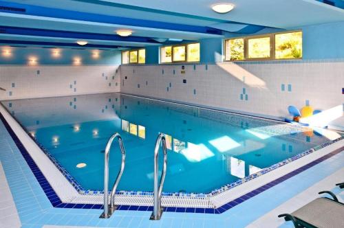 a large swimming pool in a house at Apartament Widokowy HELLO TATRY - Basen & Sauna Koscielisko in Kościelisko