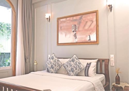 a bedroom with a bed with a fan on the wall at Yesterday Hotel in Chiang Mai