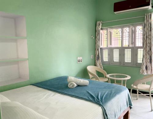 Ένα ή περισσότερα κρεβάτια σε δωμάτιο στο Kalyan Guesthouse
