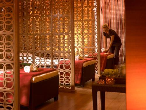a man standing in a room with two beds at Westport Plaza Hotel, Spa & Leisure in Westport