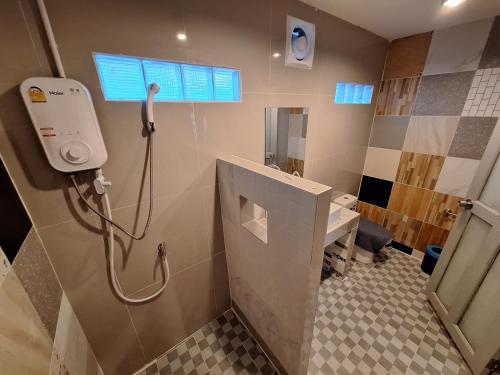 a bathroom with a shower and a toilet and a sink at Slumberland at Pai in Pai