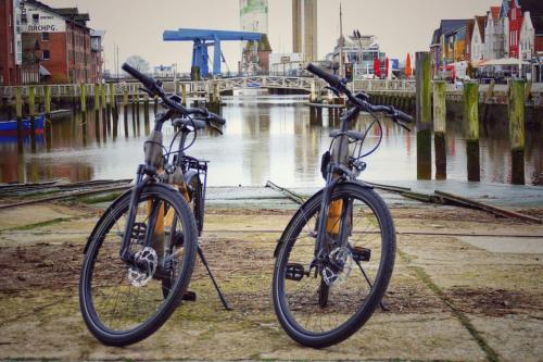 two bikes are parked next to a river at SANDglow in Husum