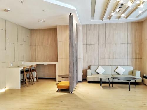 a living room with a couch and a table at K Avenue Kota Kinabalu in Donggongon