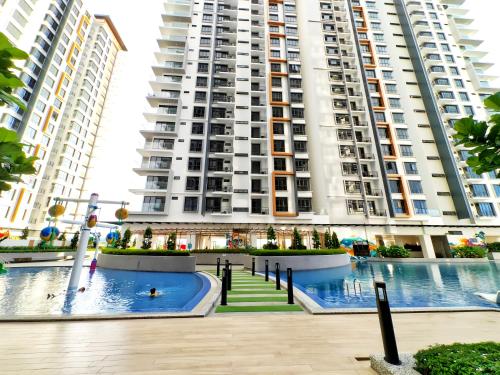 a large apartment building with a pool in front of it at K Avenue Kota Kinabalu in Donggongon
