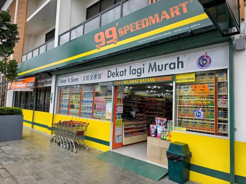 a store front of a grocery store with a yellow facade at K Avenue Kota Kinabalu in Donggongon
