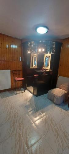 a room with a bed and a table and mirrors at Nenita Home in Nénita