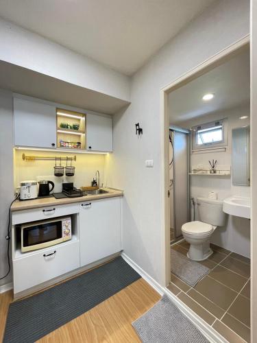 a small kitchen with a sink and a toilet at AnnaHomeB139Latkrabang in Ban Khlong Prawet