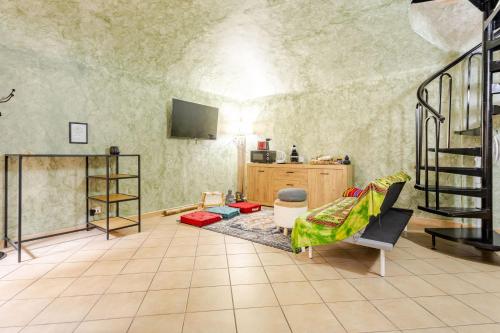 a living room with a couch and a tv at Secret Zen House in the Center W Free Parking and 24Hours Automatic Check-In - With Netflix & DisneyPlus in Casale Monferrato