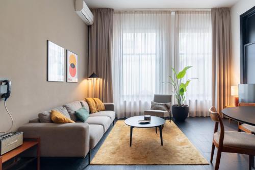 a living room with a couch and a table at The Hunfeld in Utrecht