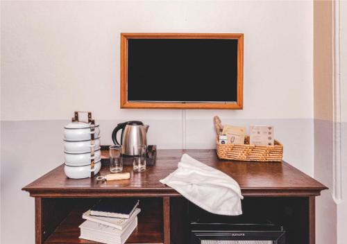 a wooden desk with a television on a wall at Yesterday Hotel in Chiang Mai