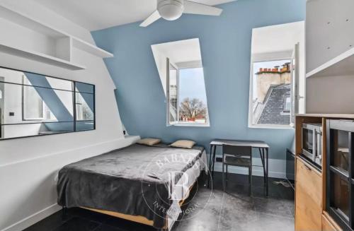a bedroom with a bed and two windows at Fantastic Studio au Coeur de Paris, à 2 minutes du Musée d'Orsay in Paris