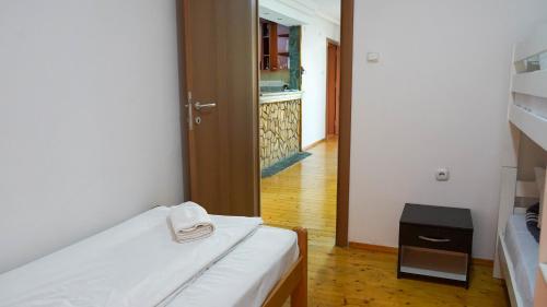 a small room with a bed and a hallway at Ivan Apartment Skopje in Skopje