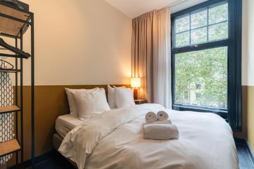 a bedroom with a bed with a towel on it at The Hunfeld in Utrecht