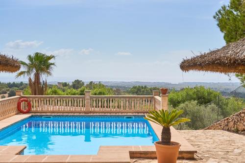 a swimming pool in a villa with a fence at Finca Puig de Sa Figuera in S'Horta