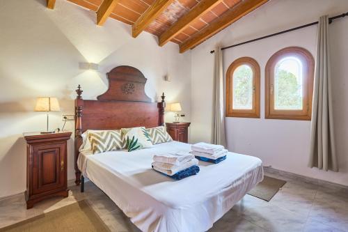 a bedroom with a large bed with two boxes on it at Finca Puig de Sa Figuera in S'Horta