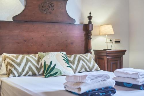 a bedroom with a bed with towels on it at Finca Puig de Sa Figuera in S'Horta