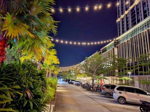 a city street at night with lights and cars parked at Newly Renovated 50th Floor CityView Unit Pollux Batam in Batam Center