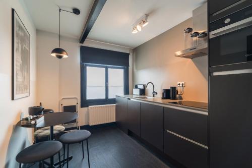 a kitchen with chairs and a table and a counter at The Hunfeld in Utrecht