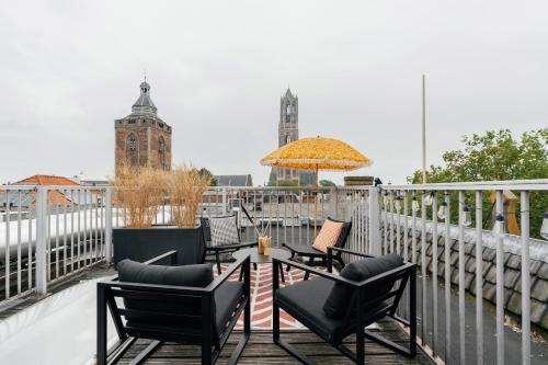 a patio with chairs and a table on a balcony at The Hunfeld in Utrecht
