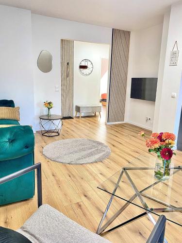 a living room with a blue couch and a glass table at Skyview Residence - Self Check In - Near City Centre in Graz