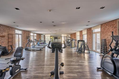 a gym with a row of treadmills and machines at Almarena Madero Urbano Affiliated by Melia in Buenos Aires