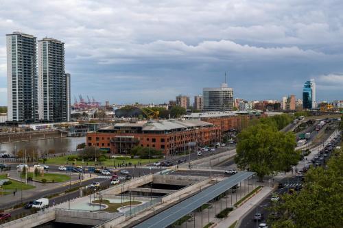 a city with a bridge and buildings and traffic at Almarena Madero Urbano Affiliated by Melia in Buenos Aires