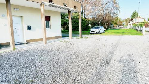a white car parked next to a house at Rustico da Pina con angolo cottura in Castions