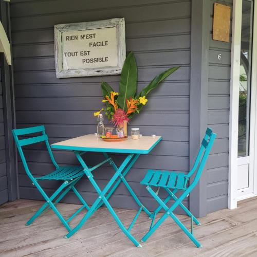 a table and two chairs on a porch at Gite Kazamax in Lamentin
