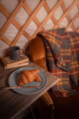 a plate of food on a table with a coffee cup at Gilfach Gower Farm Luxury Yurt with Hot Tub in Ammanford