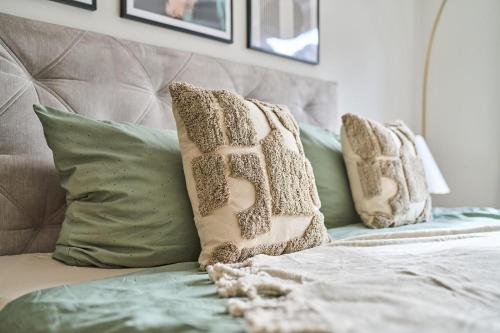 two pillows are sitting on a bed with at Apartment Mountainview in Bürs