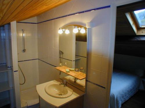 a bathroom with a sink and a mirror at La Bruyère - chez Martine in Appy
