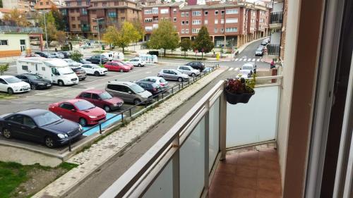 a balcony with cars parked in a parking lot at La casica de Sabi in Sabiñánigo