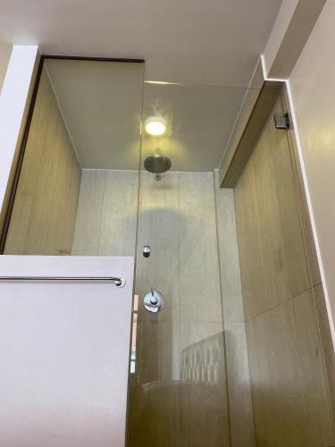 a shower with a glass door in a bathroom at Casa Murillo N826 in La Paz