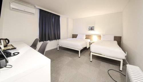 Katil atau katil-katil dalam bilik di Gaon J Stay Hotel