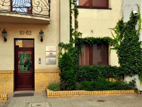 a building with a door and ivy on it at SleepWalker Boutique Suites in Wrocław