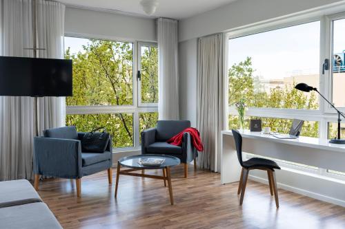 a living room with two chairs and a table at Almarena Madero Urbano Affiliated by Melia in Buenos Aires