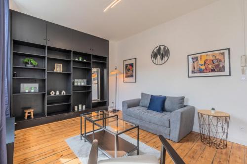 un salon avec un canapé et une table dans l'établissement 1 bedroom apartment near shops & metro, à Tourcoing