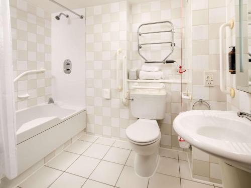 a white bathroom with a toilet and a sink at Sunday London Staines-upon-Thames Heathrow T5 in Staines