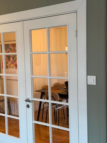 a sliding glass door with a table in a room at Villa in central Narvik! in Narvik