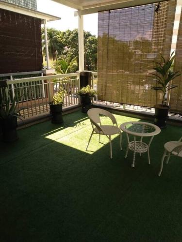 a patio with a table and chairs on a balcony at UniVilla- Ideal Family Home for 18pax in Gelugor