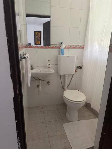 a bathroom with a toilet and a sink at Gerbera staycation in Nairobi