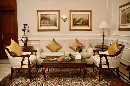 a living room with a couch and two chairs at The Imperial, New Delhi in New Delhi