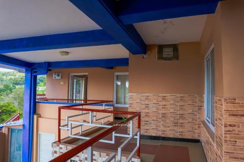 a staircase in a house with blue ceilings at Vijaya Deepa Guest House by LexStays in Coonoor