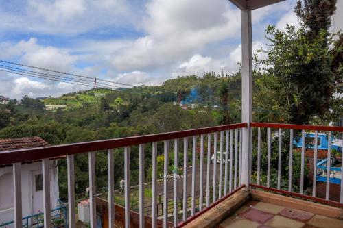 a balcony with a view of a mountain at Vijaya Deepa Guest House by LexStays in Coonoor