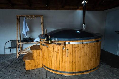 a large wooden tub in a room with a mirror at Casa Delia Toplita in Topliţa