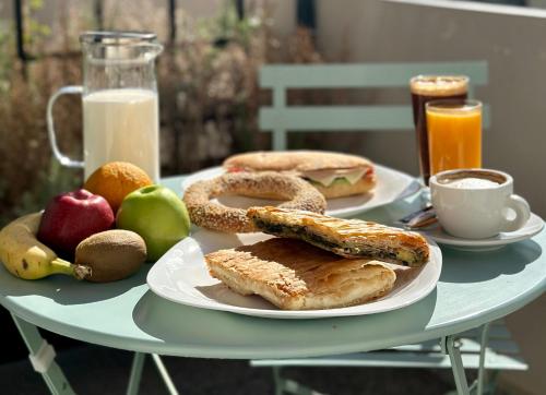 a table with two plates of breakfast foods and milk at Belle Athenes - Luxury Rooms at Monastiraki Railway Station in Athens