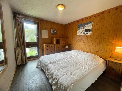 une chambre avec un lit blanc et une fenêtre dans l'établissement OURS BLANC 20 Appartement 4 pers avec belle vue, à La Clusaz